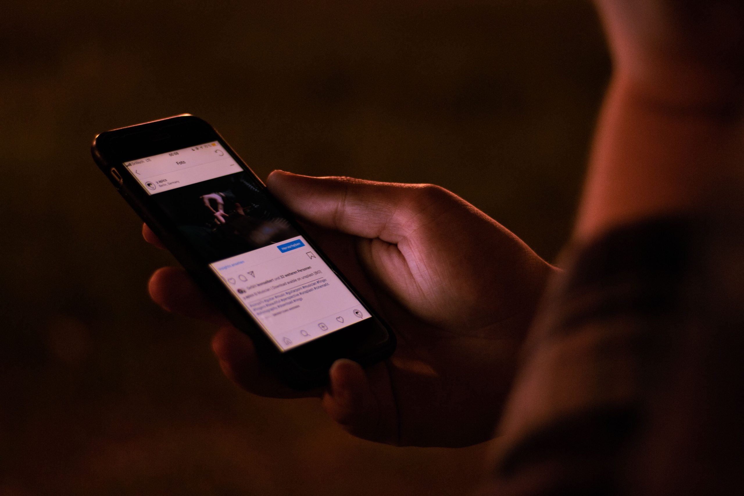 Personne utilisant un smartphone en environnement sombre