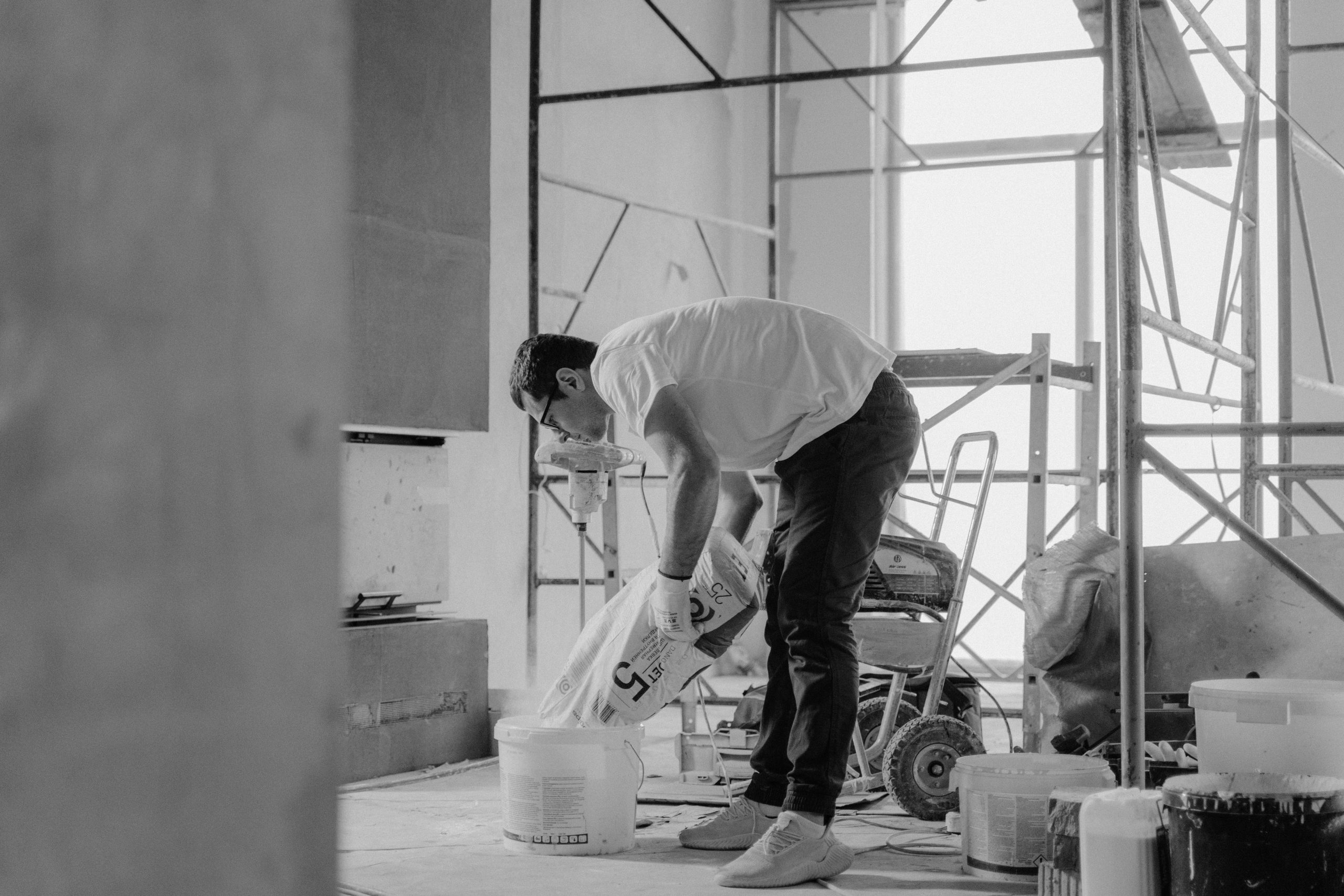 Ouvrier versant matériaux dans bâtiment rénovation